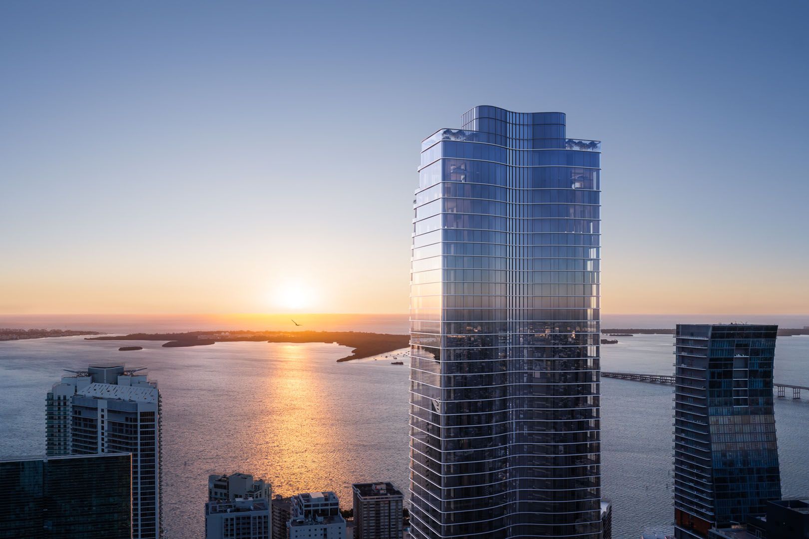 The Residences at 1428 Brickell — tower at sunset above Brickell and Biscayne Bay