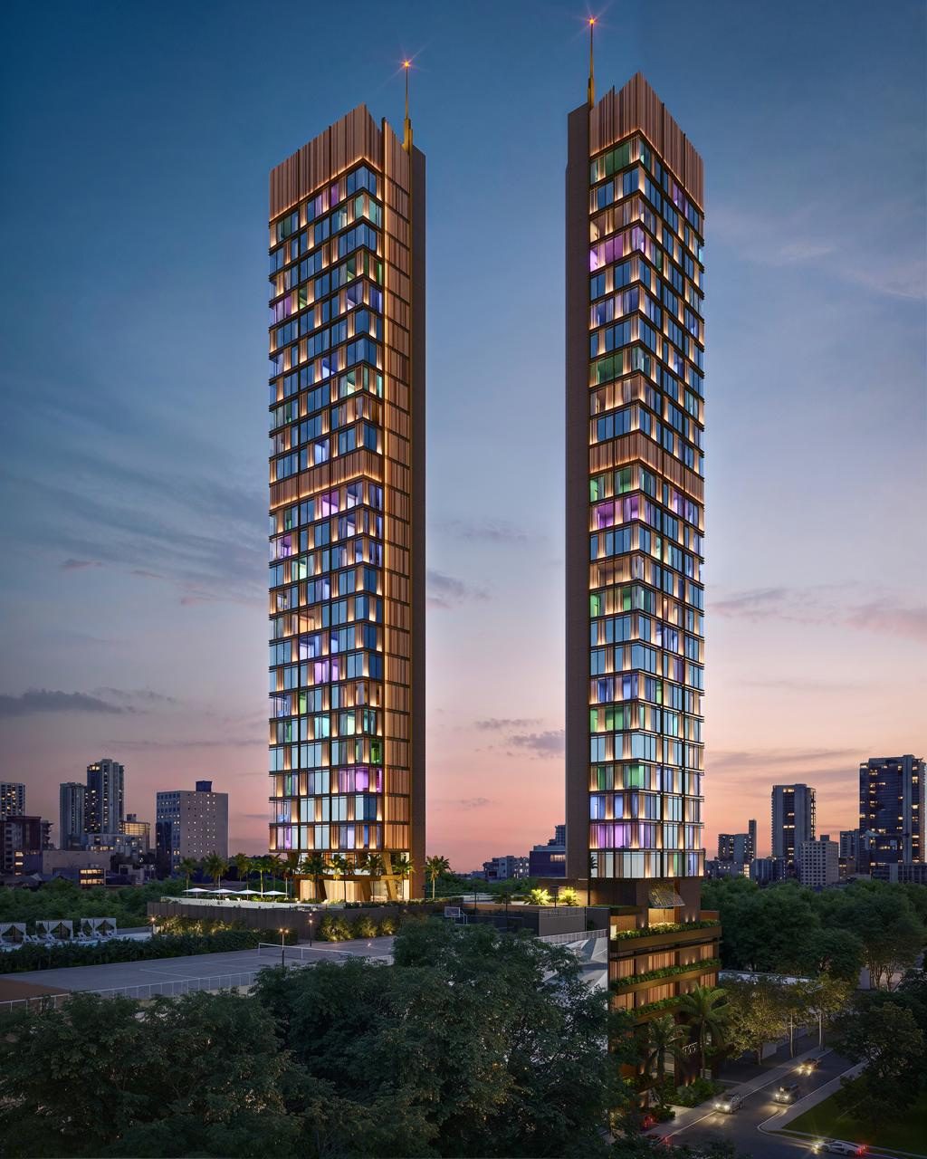 OKIRA twin towers illuminated at dusk above the Edgewater, Miami skyline